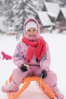 little girl sitting on sledges photo