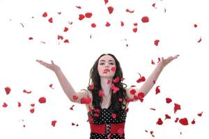 woman with falling rose petals photo