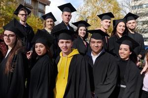 Group of diverse international graduating students celebrating photo