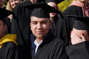 Group of diverse international graduating students celebrating photo