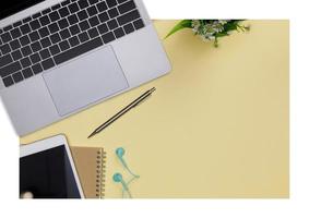 Top view workspace office supplies mockup with notebook, tablet, books and accessories isolated on yellow background, overhead view with copy space, Workspace for designer concept photo