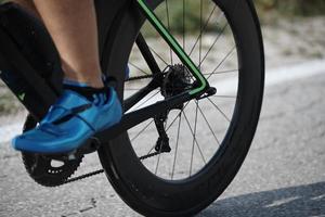 closeup of triathlon athlete riding bike photo