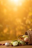 Autumn vertical composition with a basket of apples, squash, peppers on the background of an autumn landscape. Autumn harvest concept photo