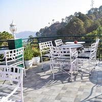 Early morning view of Modern rooftop restaurant at Kasauli, Himachal Pradesh in India, View of mountain hills from open air restaurant in Kasauli, Kasauli Rooftop restaurant photo