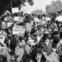 Delhi, India December 25 2021 - Delhi Contractual Guest Teachers with posters, flags and graffitis protesting against Delhi AAP Government for making policy, Delhi Teacher protesting Black and White photo