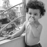 lindo niño shivaay sapra en el balcón de la casa durante el verano, dulce sesión de fotos de niño pequeño durante el día, niño pequeño disfrutando en casa durante la sesión de fotos - blanco y negro