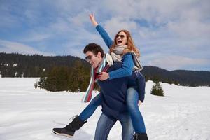 happy young couple having fun on fresh show on winter vacation photo