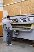 worker in a factory of wooden furniture photo