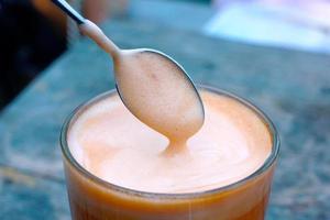 soft focus tea cup and teaspoon. Pouring  on tea cup photo