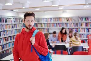 the student uses a laptop and a school library photo