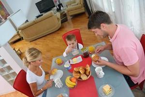 family have healthy breakfast at home photo