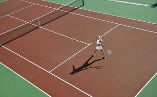 young woman play tennis outdoor photo