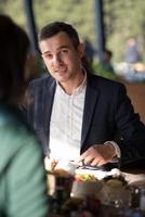 Closeup shot of young woman and man having meal. photo