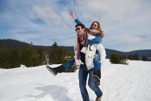 happy young couple having fun on fresh show on winter vacation photo