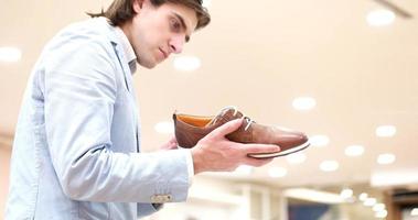 Man Chooses Shoes At Shoe Store photo