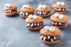 Cookies with chocolate paste in the form of monsters for Halloween photo