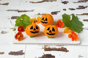 Drawn funny faces on Mandarin oranges for Halloween photo