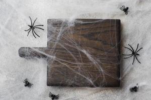 Wooden cutting Board in the background of the web spiders. Concept Halloween. photo