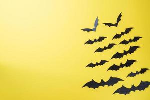 Scenery bats on a yellow background. Concept Halloween. photo