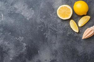 Ripe lemon and lemon slices on grey background with copy space. photo