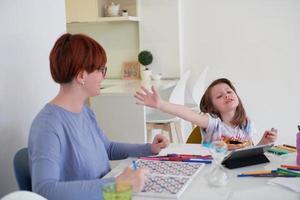 Mother and little daughter  playing together  drawing creative artwork photo