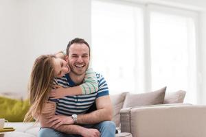 young handsome couple hugging on the sofa photo