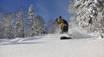 freestyle snowboarder jump and ride photo