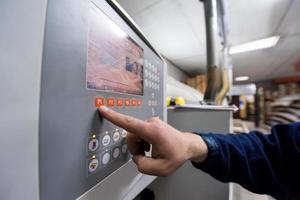 carpenter calculating and programming a cnc wood working machine photo