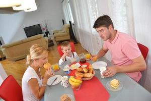 family have healthy breakfast at home photo