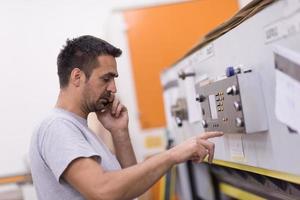 engineer in front of wood cutting machine photo