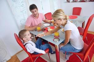 family have healthy breakfast at home photo