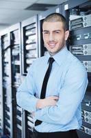 young it engineer in datacenter server room photo