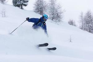 freeride skier skiing in deep powder snow photo