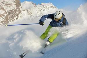 skiing on fresh snow at winter season at beautiful sunny day photo