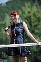 young woman play tennis game outdoor photo