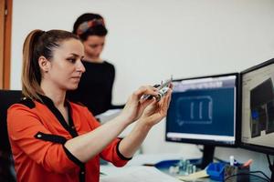 Within the heavy industry, a factory industrial engineer measures with a caliper and on a personal computer Designs a 3D model photo