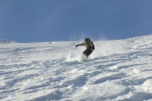 freestyle snowboarder jump and ride photo