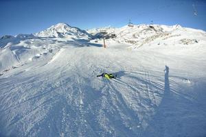 esquiar en nieve fresca en la temporada de invierno en un hermoso día soleado foto