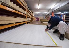 carpenter measuring wooden board photo