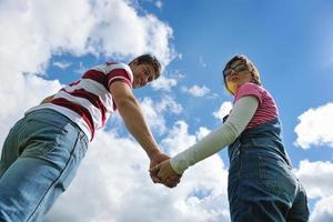 Portrait of romantic young couple smiling together outdoor photo