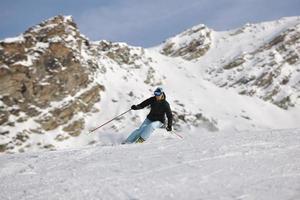 woman skiing on fresh snow at winter season photo