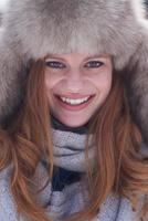 portrait of beautiful young redhair woman in snow scenery photo