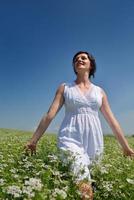 Young happy woman in green field photo