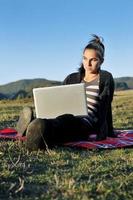 young teen girl work on laptop outdoor photo