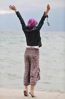beautiful young woman on beach with scarf photo