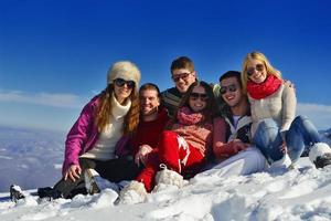 los amigos se divierten en invierno con nieve fresca foto