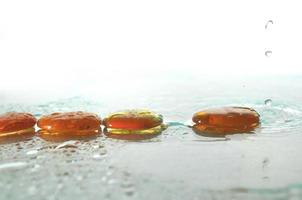 isolated wet zen stones with splashing  water drops photo