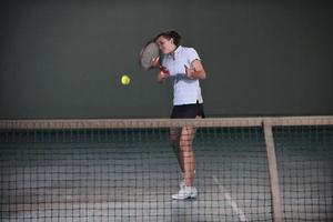 Playing tennis indoors photo