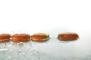 isolated wet zen stones with splashing  water drops photo