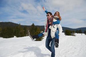 happy young couple having fun on fresh show on winter vacation photo